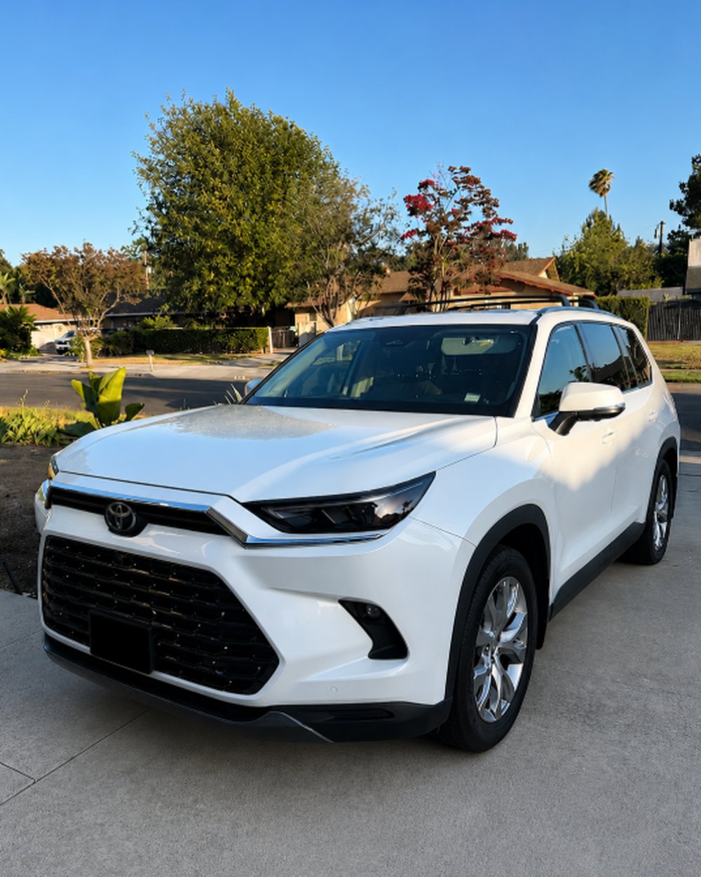 Freshly detailed white Toyota Grand Highlander in a driveway